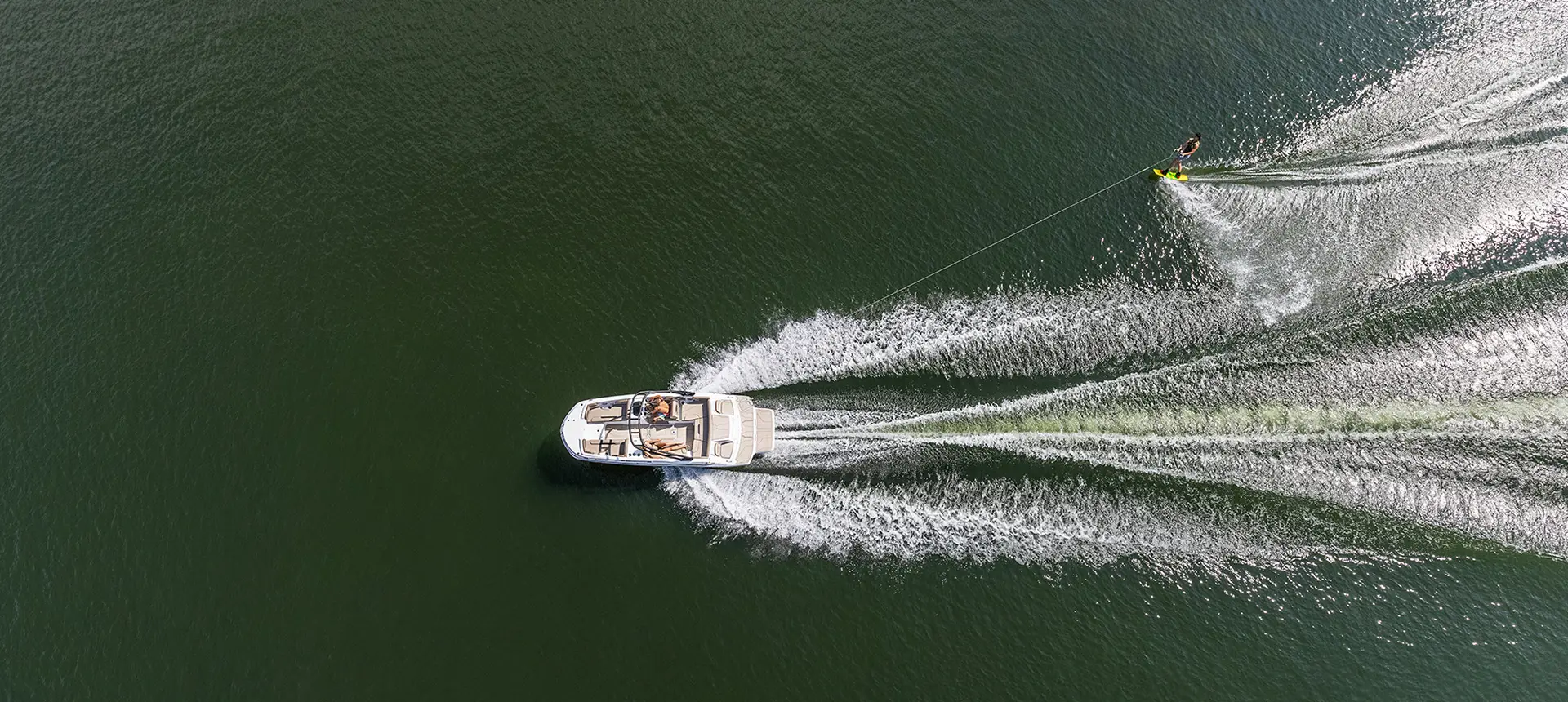 Aerial view of a hurricane boat pulling a person wakeboarding