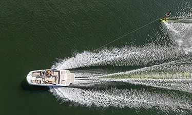Aerial view of a hurricane boat pulling a person wakeboarding