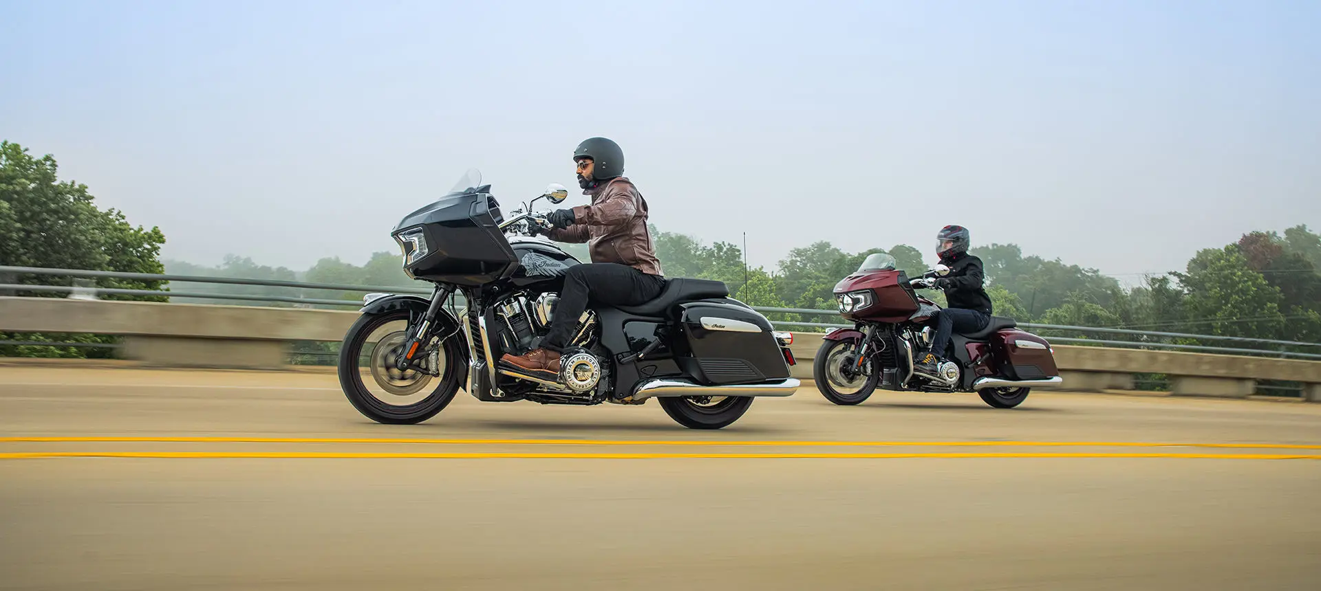 2 riders cruising down the highway on their indian challenger motorcycles