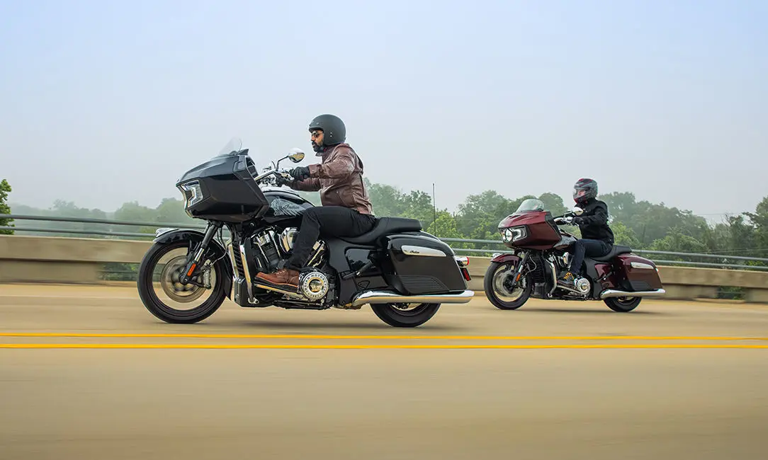2 riders cruising down the highway on their indian challenger motorcycles