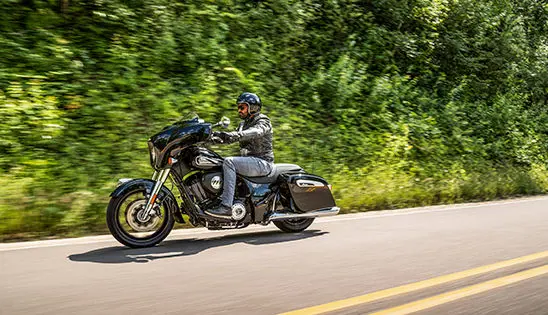 man cruising on a indian chieftain motorcycle