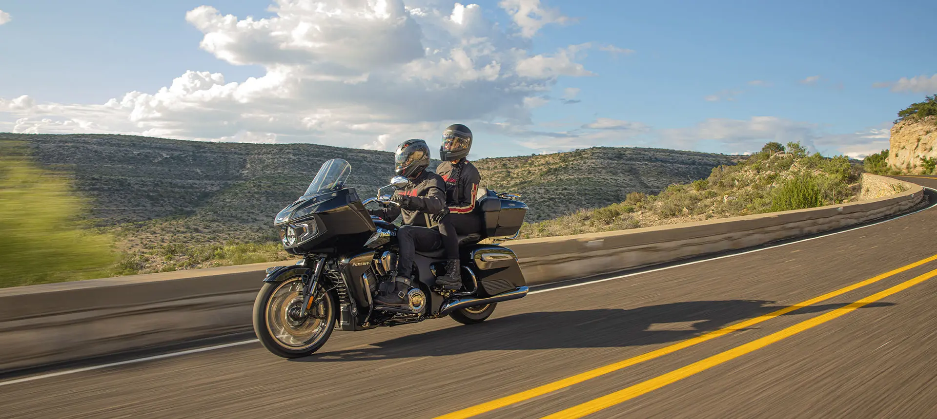 couple riding safely on their indian pursuit limited motorcycle