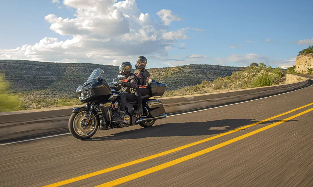 couple riding safely on their indian pursuit limited motorcycle