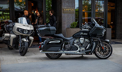 couple relaxing off-road after a ride on their indian chief motorcycles