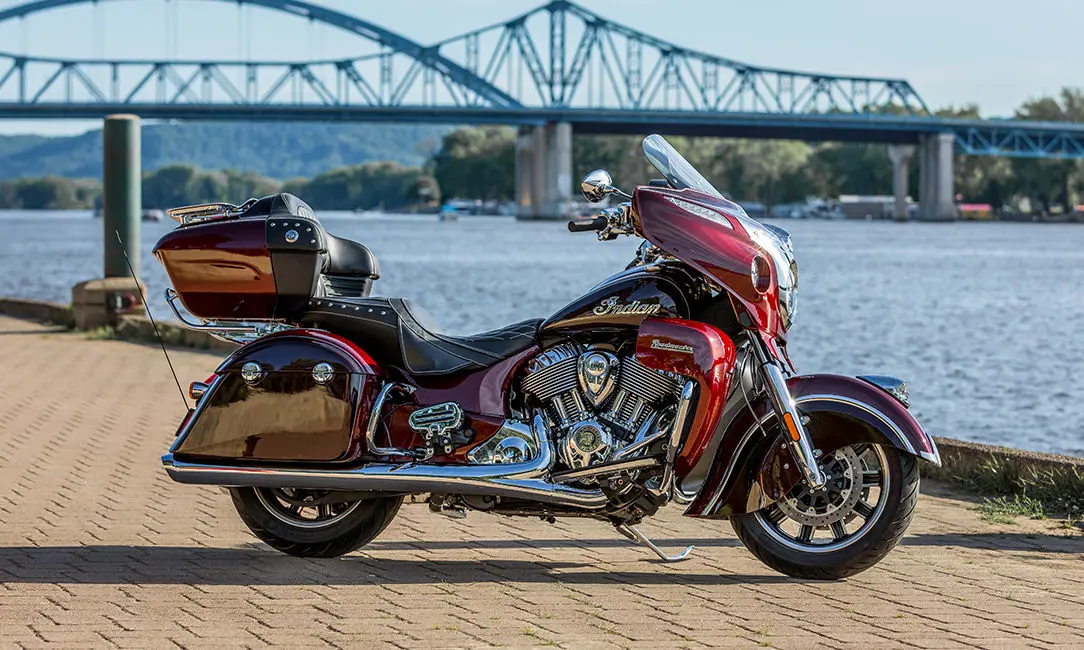 maroon metallic indian roadmaster motorcycle parked by the water
