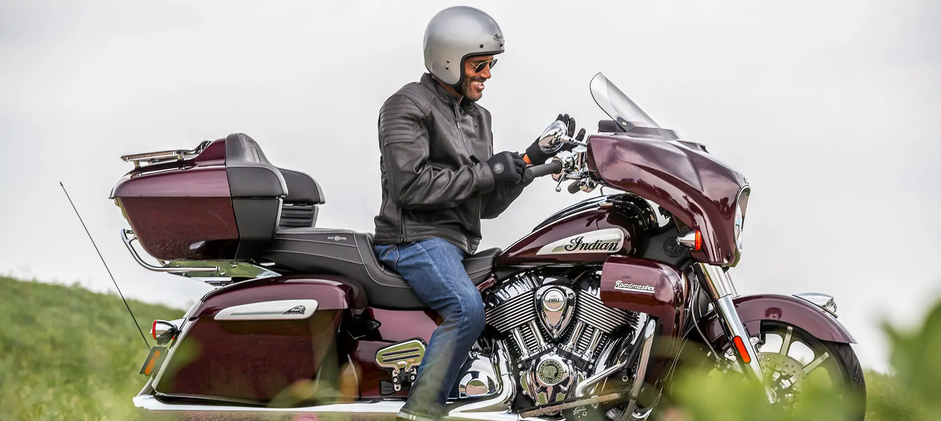 man getting ready for a ride on his indian roadmaster limited motorcycle