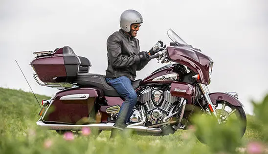 man getting ready for a ride on his indian roadmaster limited motorcycle