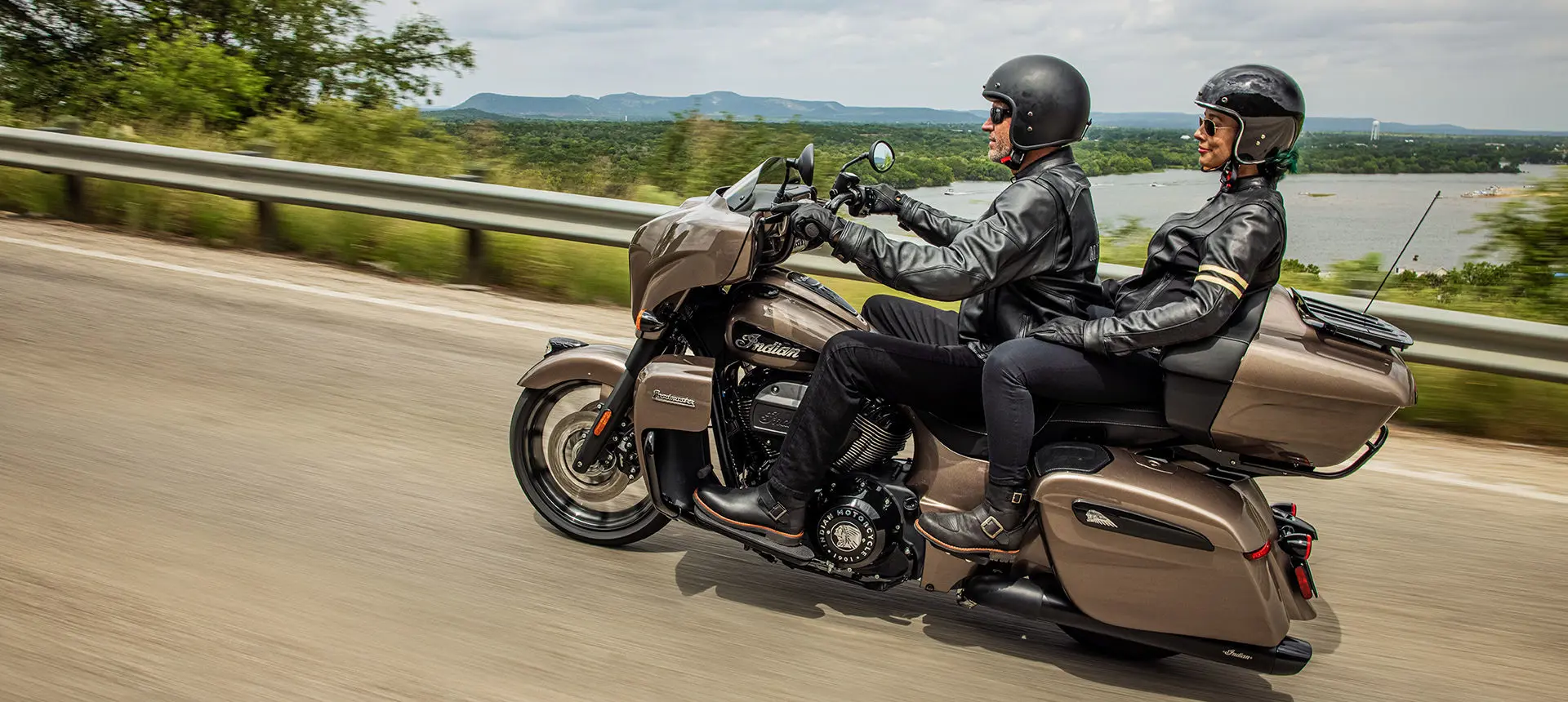 2 riders cruising on an indian roadmaster dark horse motorcycle