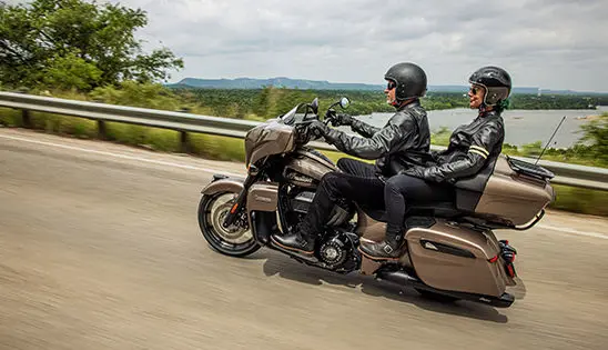 2 riders cruising on an indian roadmaster dark horse motorcycle