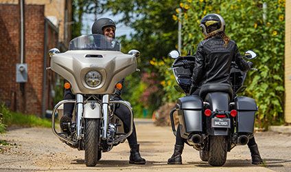 2 bikers chatting on their parked indian chieftain limited motorcycles