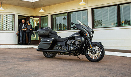 couple walking towards their indian roadmaster dark horse motorcycle