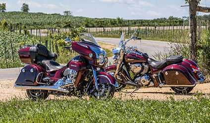 maroon metallic indian motorcycles glimmering in the sunlight