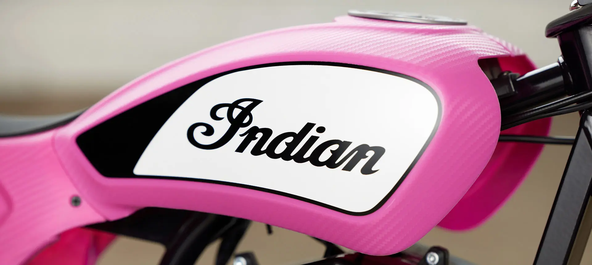 Close-up and the Indian Motorcycles logo on a eFTR Mini Pink