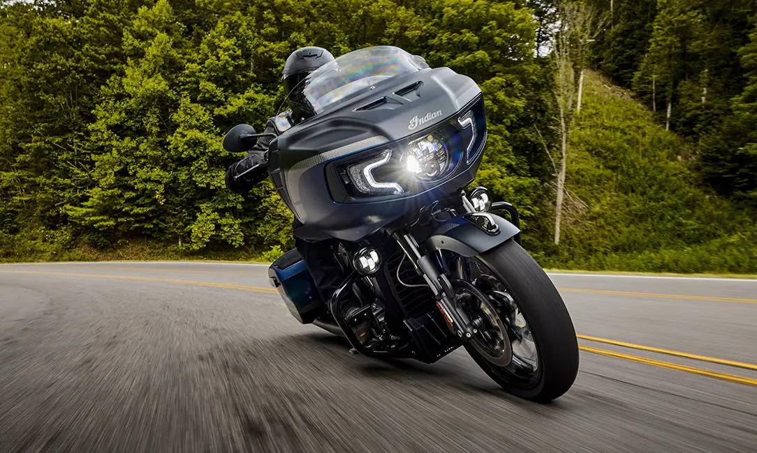 person riding a sapphire blue smoke indian challenger elite motorcycle
