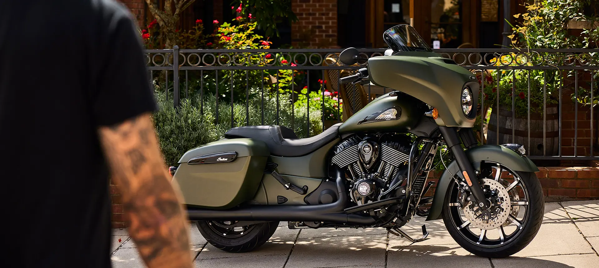 man walking towards a sagebrush smoke indian chieftain dark horse motorcycle