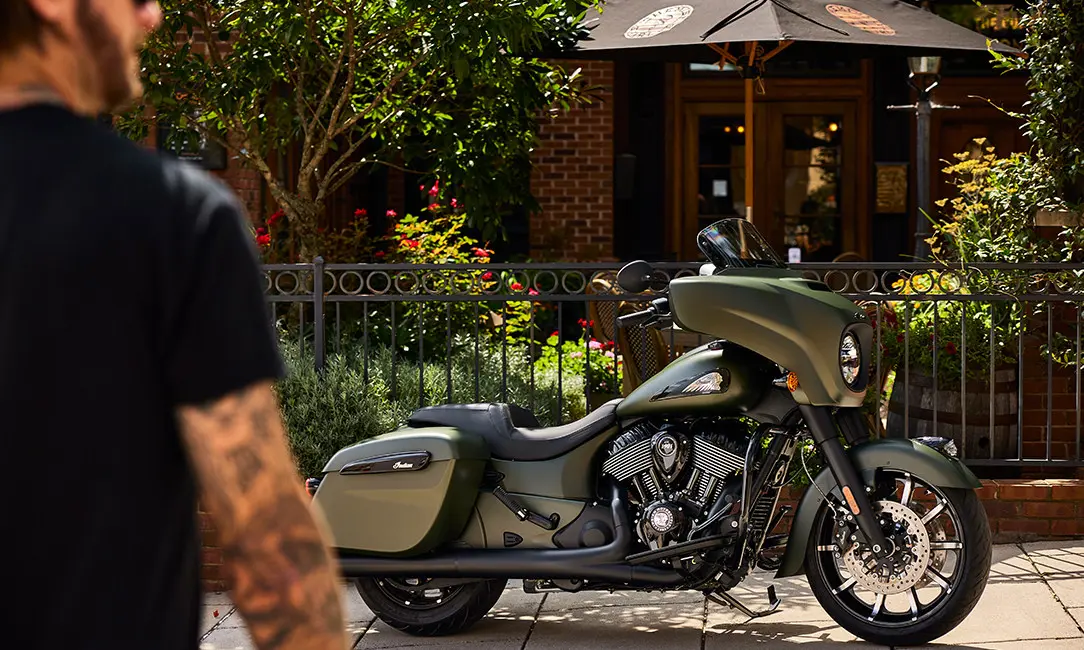 man walking towards a sagebrush smoke indian chieftain dark horse motorcycle