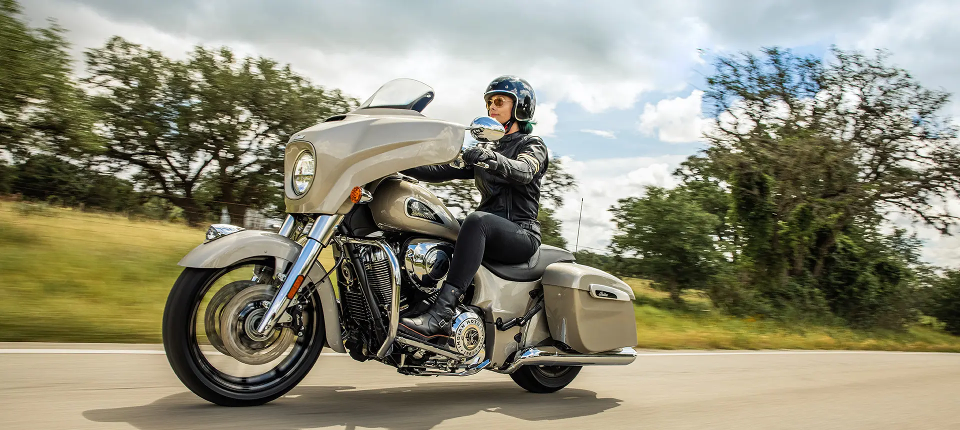 woman riding a silver quartz metallic indian chieftain limited motorcycle