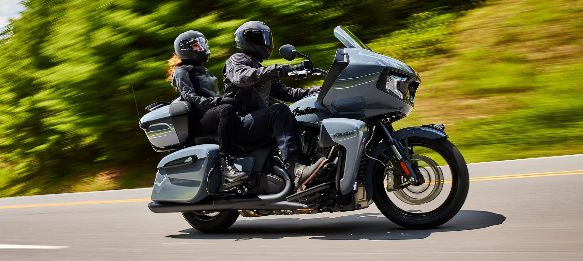 a couple cruising on an indian pursuit motorcycle