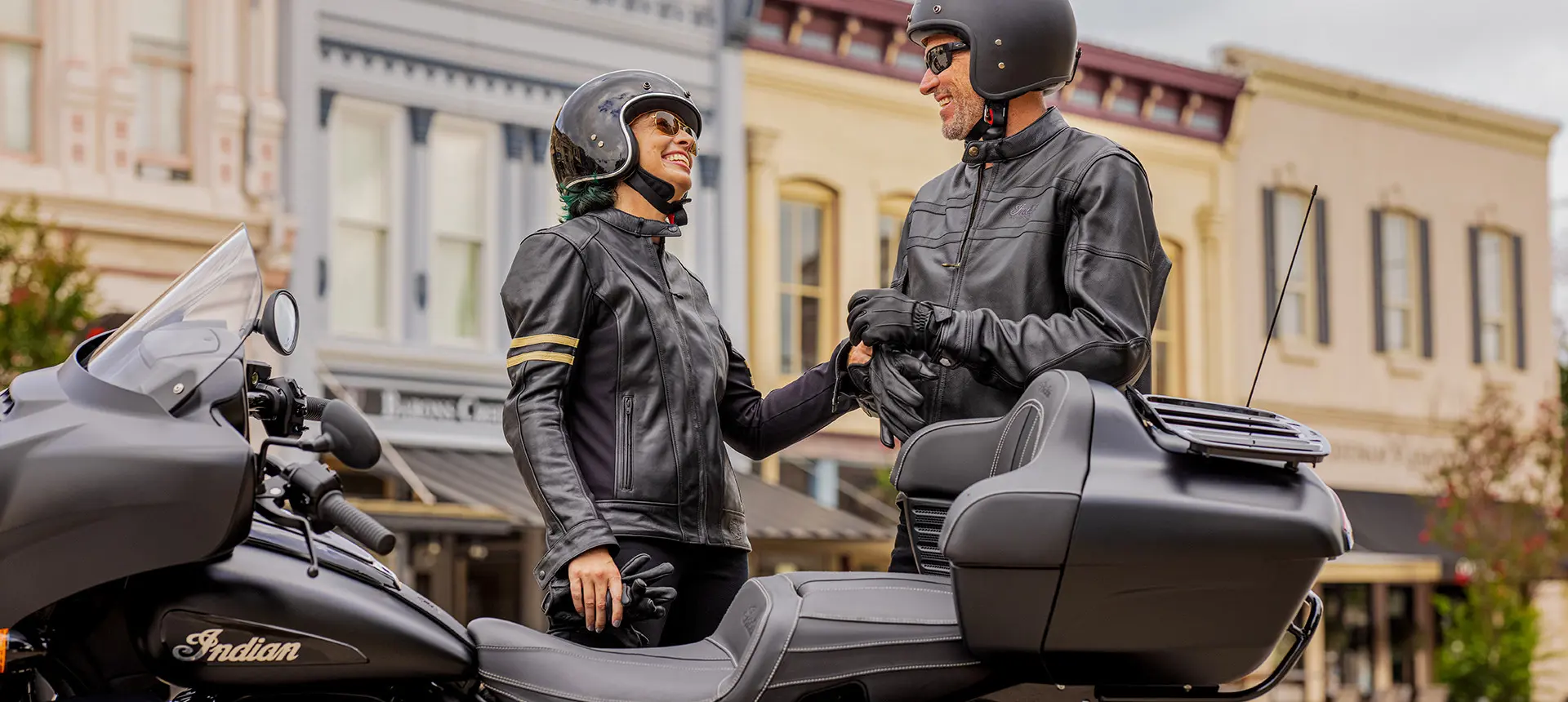 a couple getting ready for a cruise on their indian roadmaster dark horse motorcycle