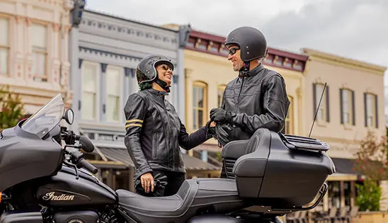 a couple getting ready for a cruise on their indian roadmaster dark horse motorcycle