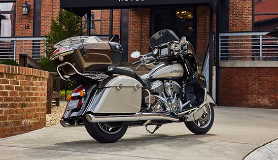 an indian roadmaster motorcycle parked by a building