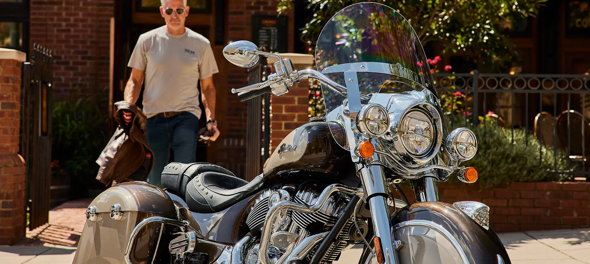 man walking towards an indian springfield motorcycle