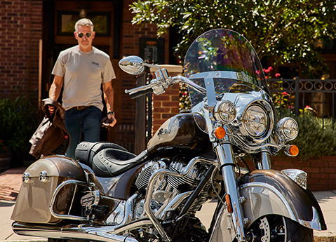Man walking towards an indian springfield motorcycle