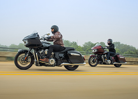 two people riding on a 2024 indian challenger limited motorcycles