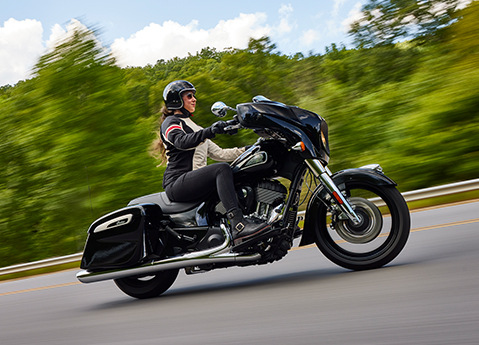 woman riding a 2024 indian chieftain motorcycle down the highway