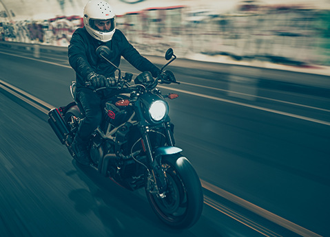 Person riding a 2024 Indian FTR x 100% R Carbon standard motorcycle.