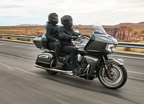 two people riding on a 2024 indian pursuit limited motorcycle
