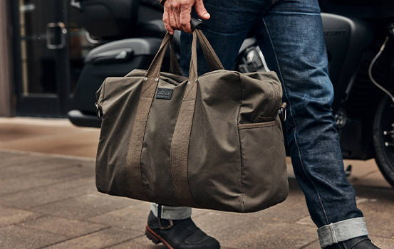 Man carrying Indian Motorcycle duffel bag. 