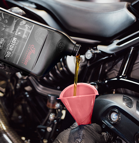 Service tech pouring oil