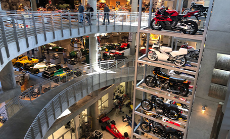 Lineup of dozens of parked motorcycles inside Barber Vintage Festival. 