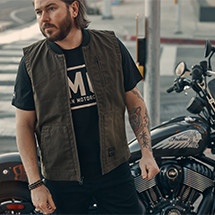 man standing near an indian motorcycle in an indian motorcycles t-shirt