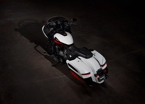 Overhead view of a 2025 Indian Challenger Elite bagger motorcycle parked in a dark garage.