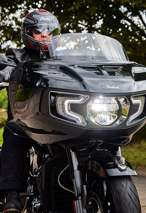 Person with a helmet riding a 2025 Indian Challenger bagger motorcycle.