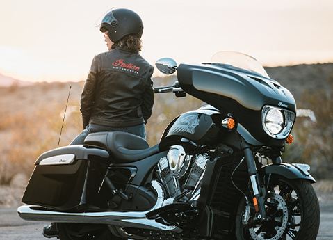 A woman in a helmet and Indian Motorcycle coat sitting on a 2025 Indian Chieftain PowerPlus motorcycle.