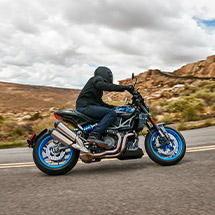 Person riding a 2024 Indian FTR Sport standard motorcycle on the highway.