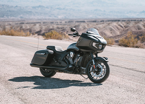 A 2025 Indian Challenger Dark Horse with 112 motorcycle parked on the side of a road.