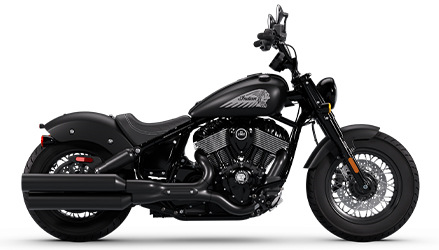 Side profile of a 2025 Indian Chief Bobber Dark Horse cruiser motorcycle in Maroon Metallic.