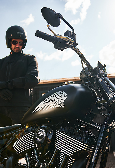 Man preparing to ride his 2025 Indian Chief Bobber Dark Horse cruiser motorcycle.