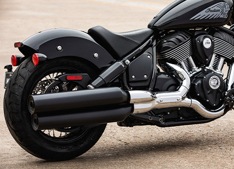 Closeup of the pipes, seat and rear fender on a 2025 Indian Chief Bobber cruiser motorcycle.
