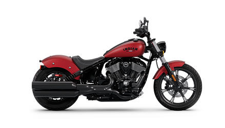 Side profile of a 2025 Indian Chief Dark Horse cruiser motorcycle in Sunset Red Smoke.