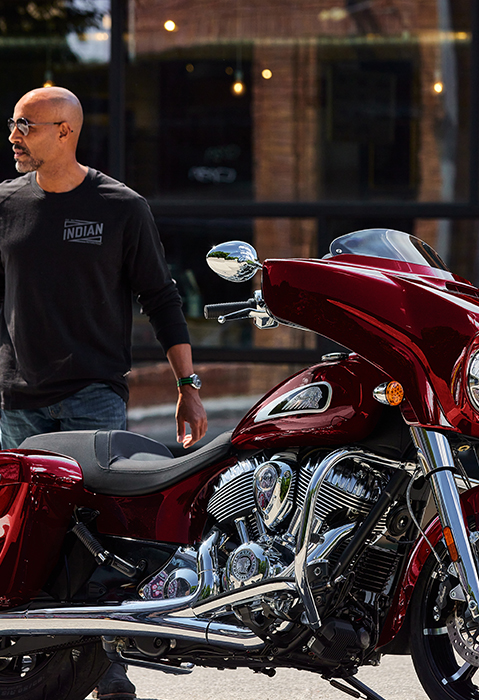 Man walking towards a 2025 Indian Chieftain Limited bagger motorcycle.