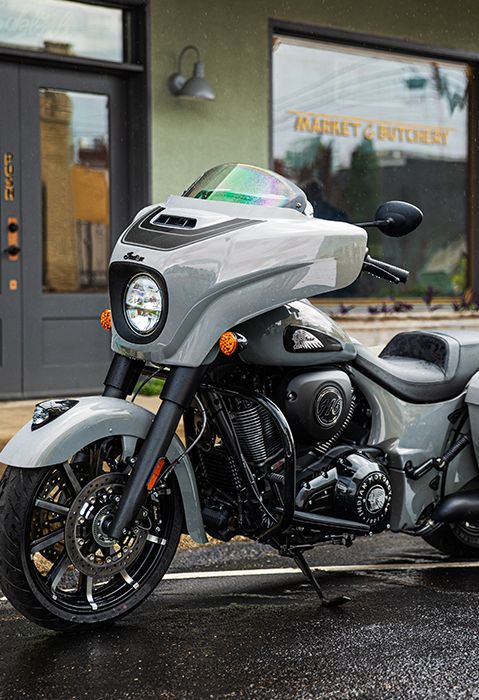 Side profile of a 2025 Indian Chieftain Dark Horse bagger motorcycle parked on a city street.