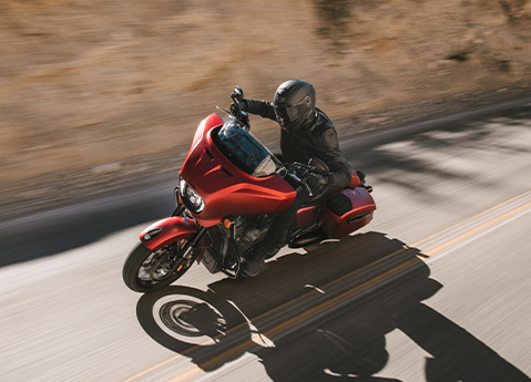 A rider with a helmet on cruising on a 2025 Indian Chieftain PowerPlus Limited with 112 motorcycle.