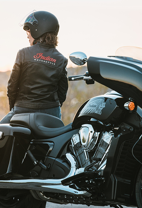 Woman in an Indian Motorcycle jacket sitting on a 2025 Indian Chieftain PowerPlus motorcycle.