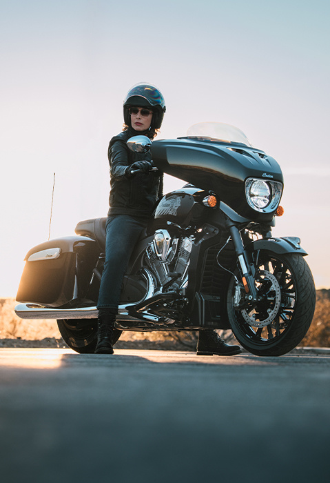 Woman in a helmet sitting on a 2025 Indian Chieftain PowerPlus motorcycle.