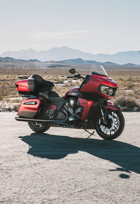 A 2025 Indian Pursuit Dark Horse motorcycle parked near a desert.